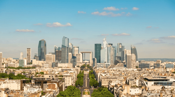 The towers of La Défense and the Grande Arche seen along the avenue from central Paris