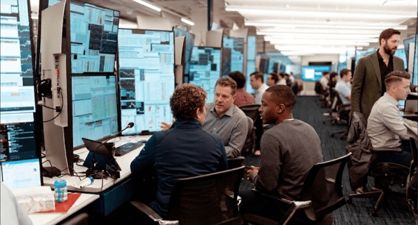 Rows of monitors on a quantitative trading floor showing live market data